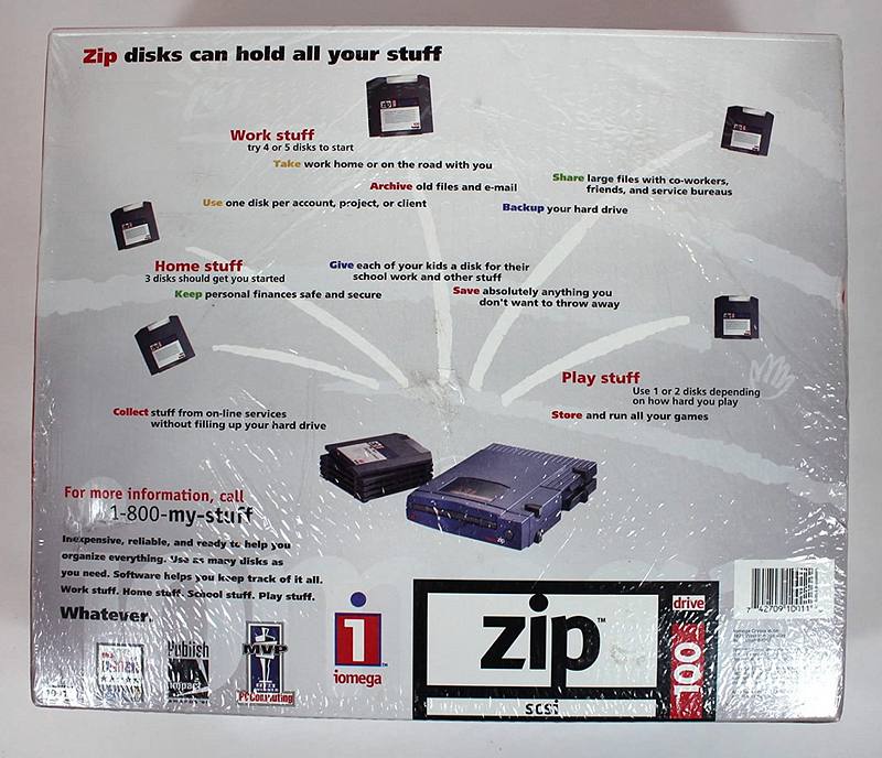 Retail packaging for an Iomega Zip disk from the mid-1990s, photographed flat, its marketing copy about work, home and play storage still legible.
